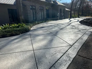 Elegant curved concrete patio with decorative scoring in luxury outdoor living space