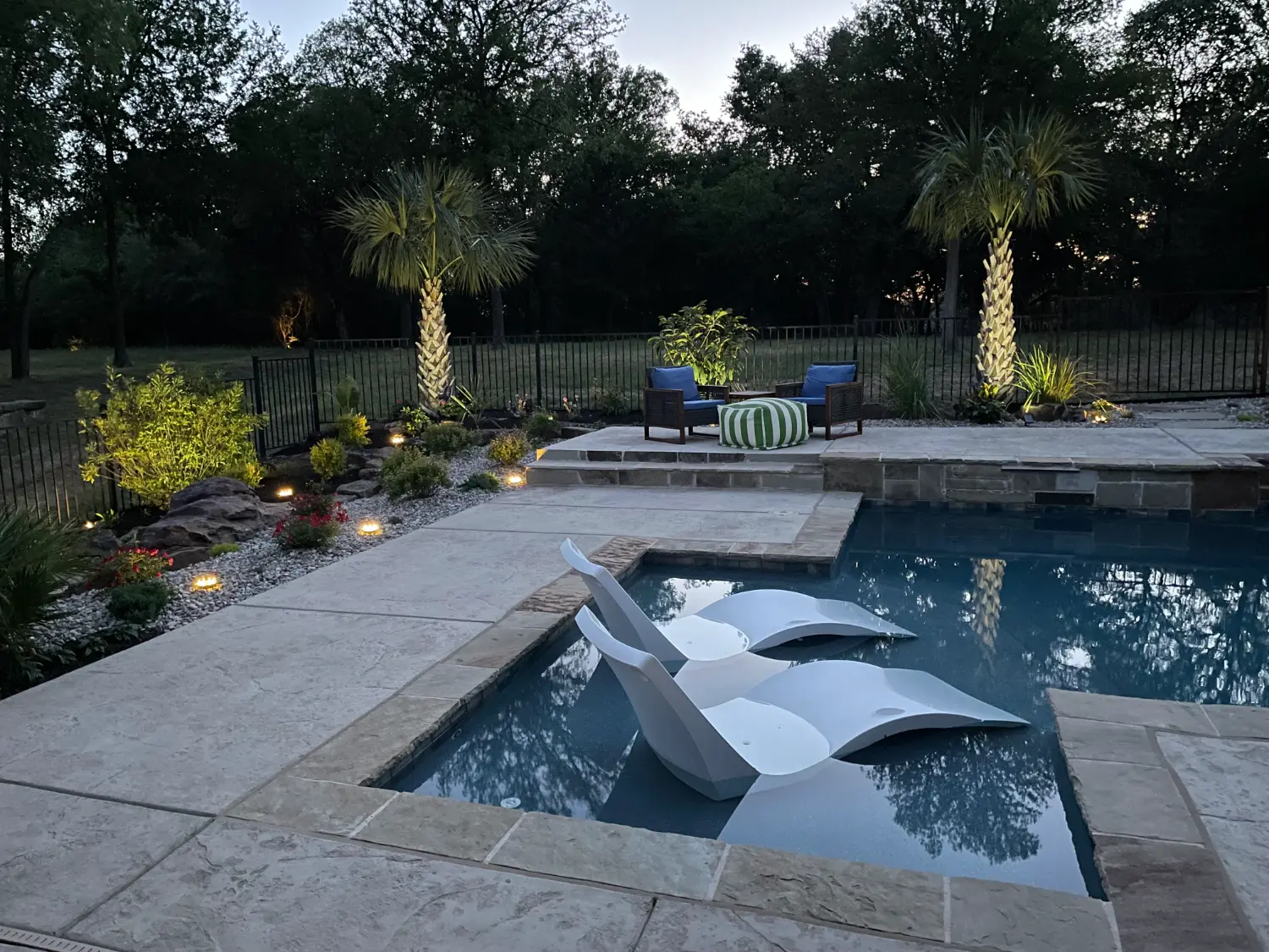 Luxury backyard transformation featuring custom pool with spa jets, elegant patio, and upscale outdoor entertainment area in Fort Worth