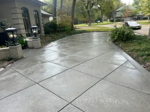 Elegant concrete patio with geometric scoring showcasing custom outdoor living design in Fort Worth residential landscape