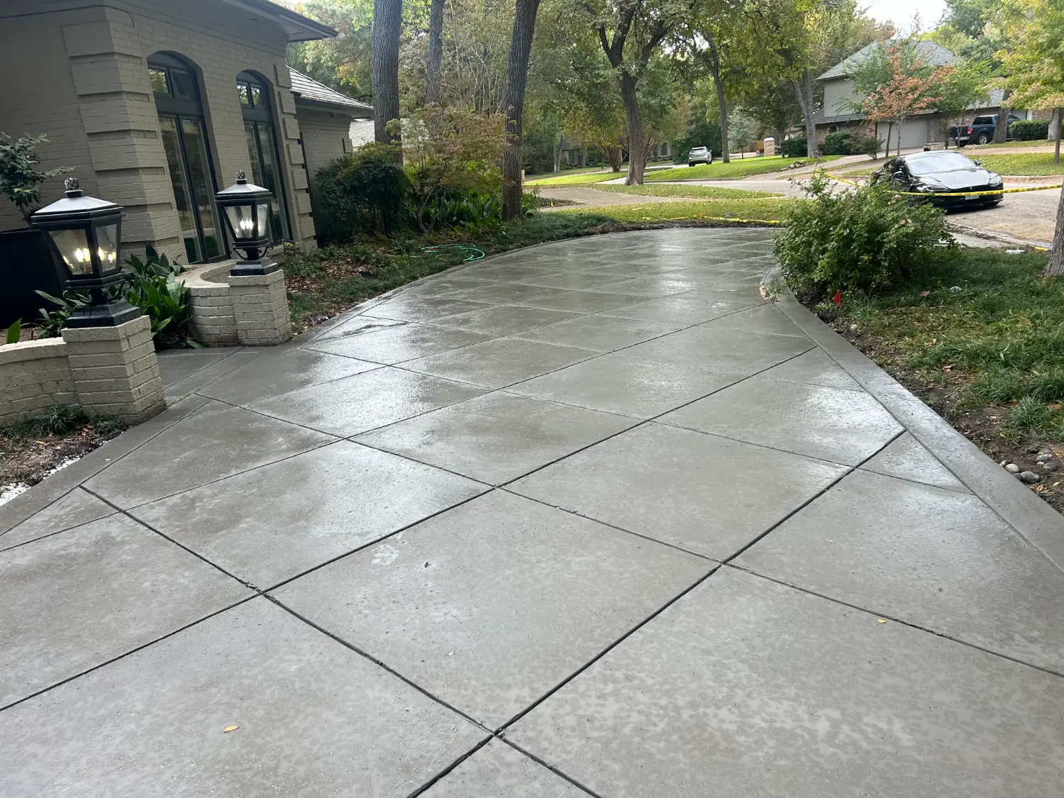 Elegant concrete patio with geometric scoring showcasing custom outdoor living design in Fort Worth residential landscape