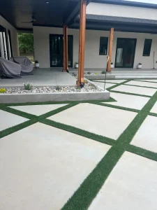 Modern luxury patio with geometric concrete pavers and artificial turf outdoor living space