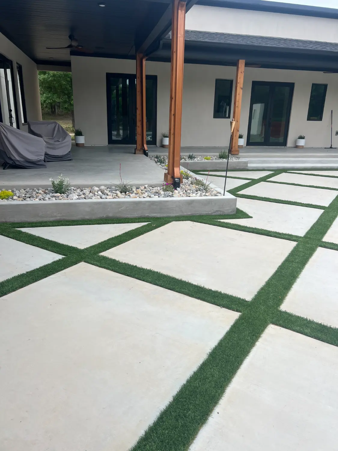 Modern luxury patio with geometric concrete pavers and artificial turf outdoor living space