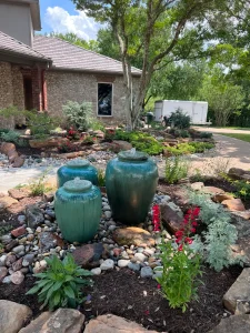 Luxury landscape design featuring turquoise water features and vibrant gardens in Fort Worth backyard