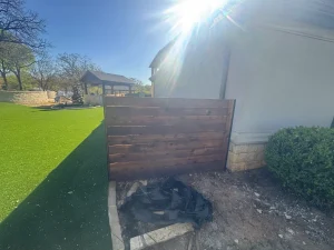 Luxury backyard transformation featuring custom wooden gate and manicured landscape design Fort Worth
